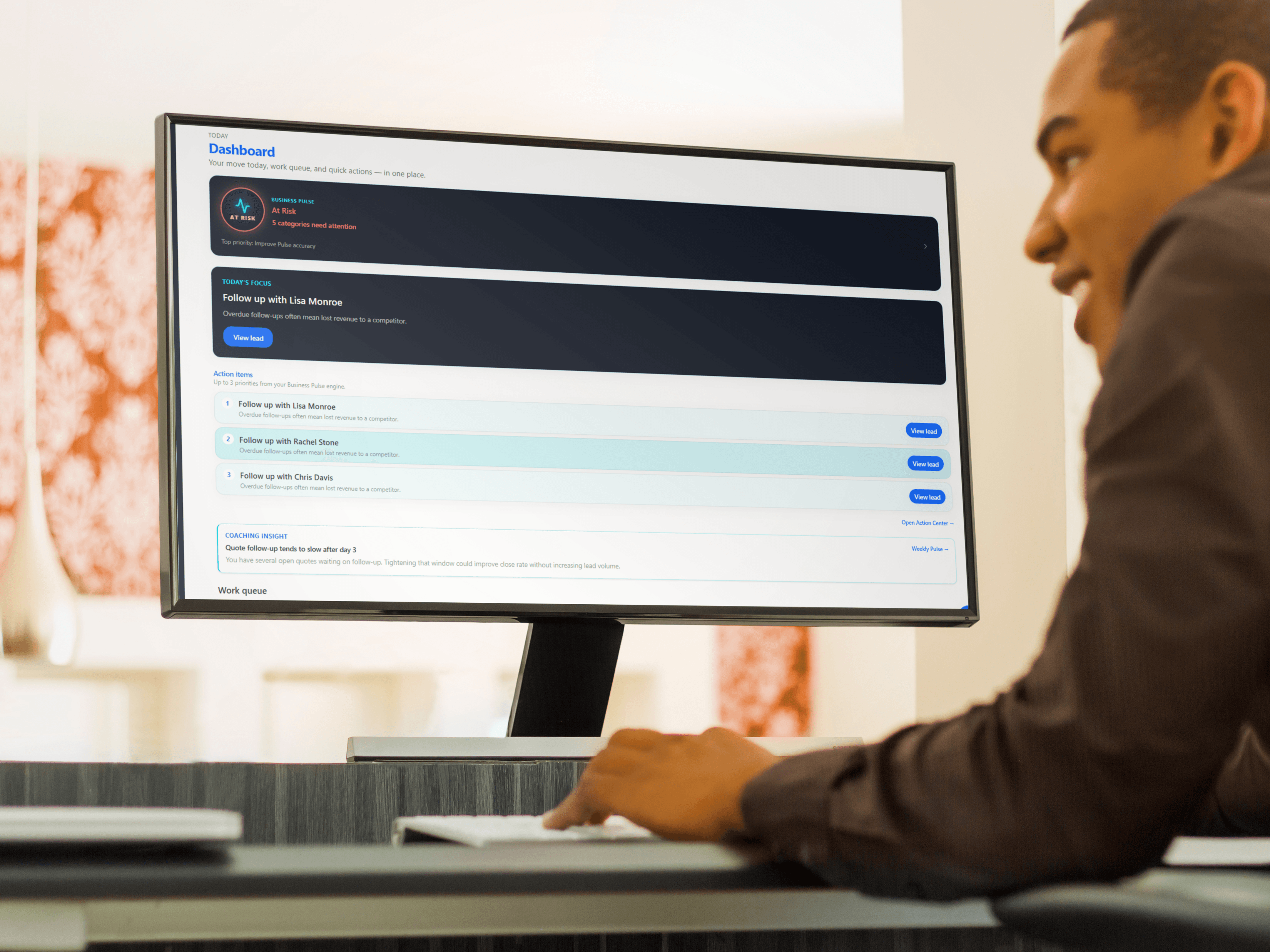 A person using Job Pulse on a desktop monitor, with the dashboard and action items on screen